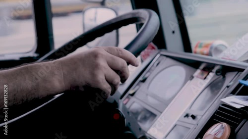 Driver driving a truck with his hands on the steering wheel