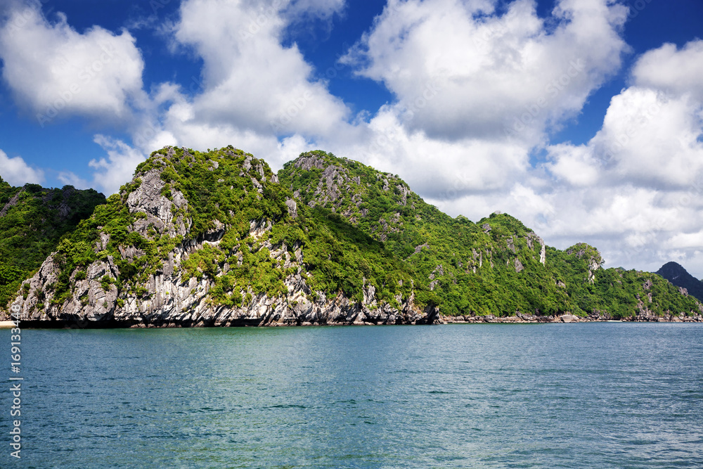 boats among beautiful limestone rocks of Lan Ha bay, the twin of Ha Long bay ona sunny day, Vietnam