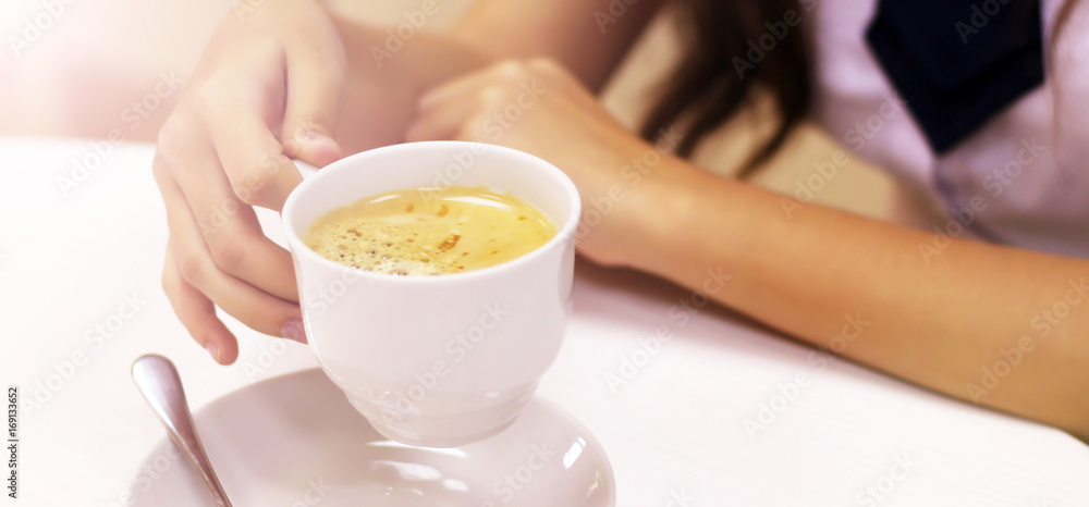 hand holding a cup of coffee, sunlight hand holding a cup of coffee, sunlight
