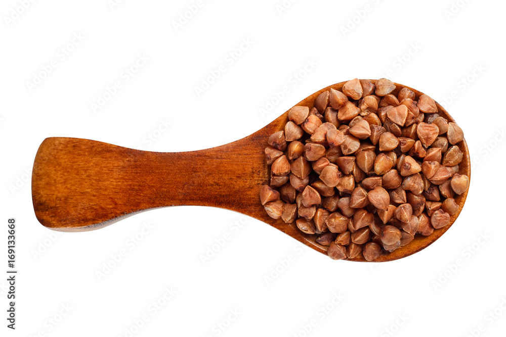 Fototapeta premium Buckwheat in a wooden spoon on a white background