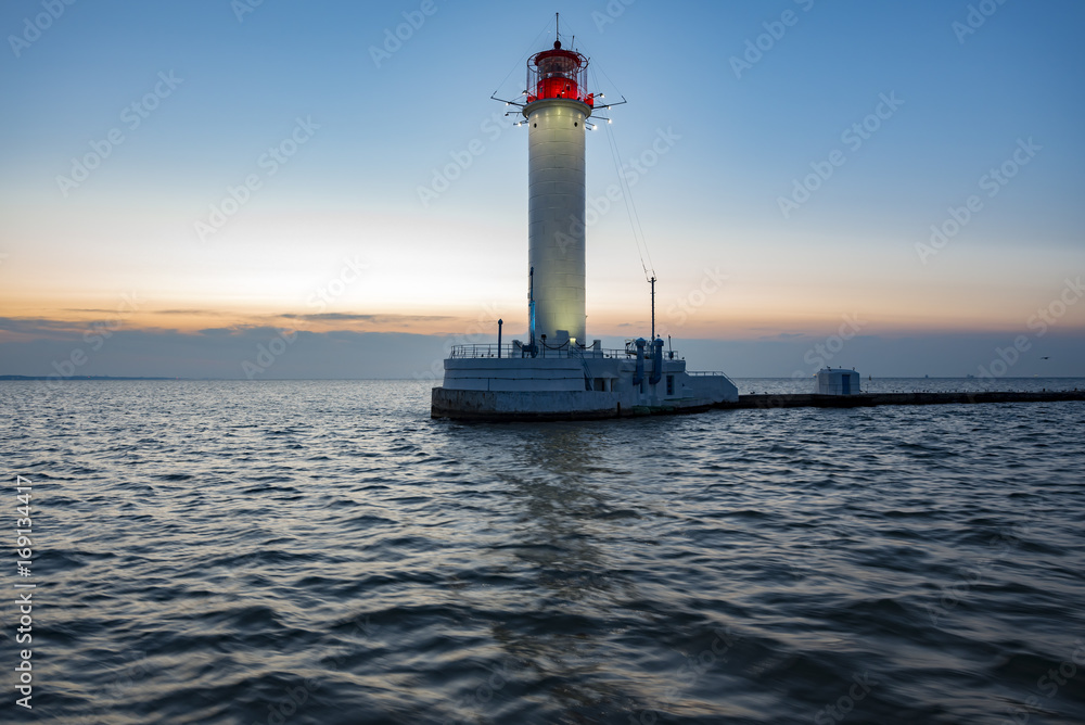 Beautiful lighthouse in the sea in sunrise Beautiful lighthouse in the sea in sunrise