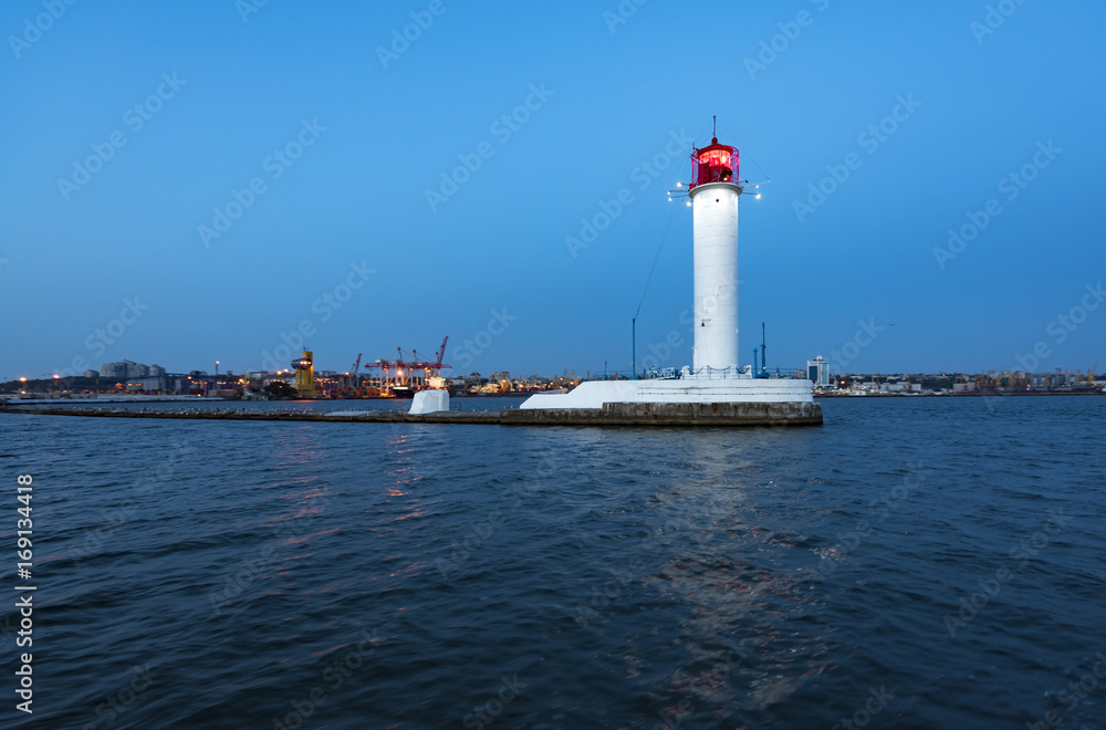 White beautiful lighthouse in the sea in dusk time White beautiful lighthouse in the sea in dusk time