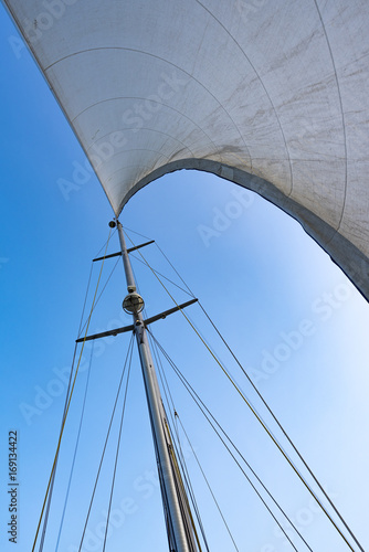 The white sail and mast of yacht
