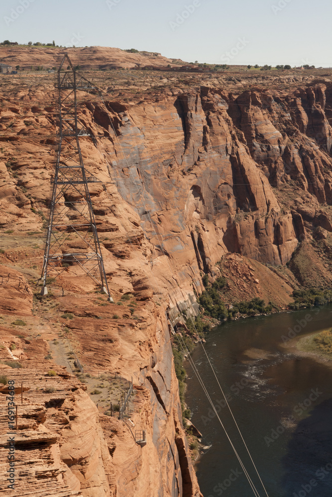 Pylon on a red rock cliff by the Colorado river at Glen Canyon Dam, Page, Arizona.