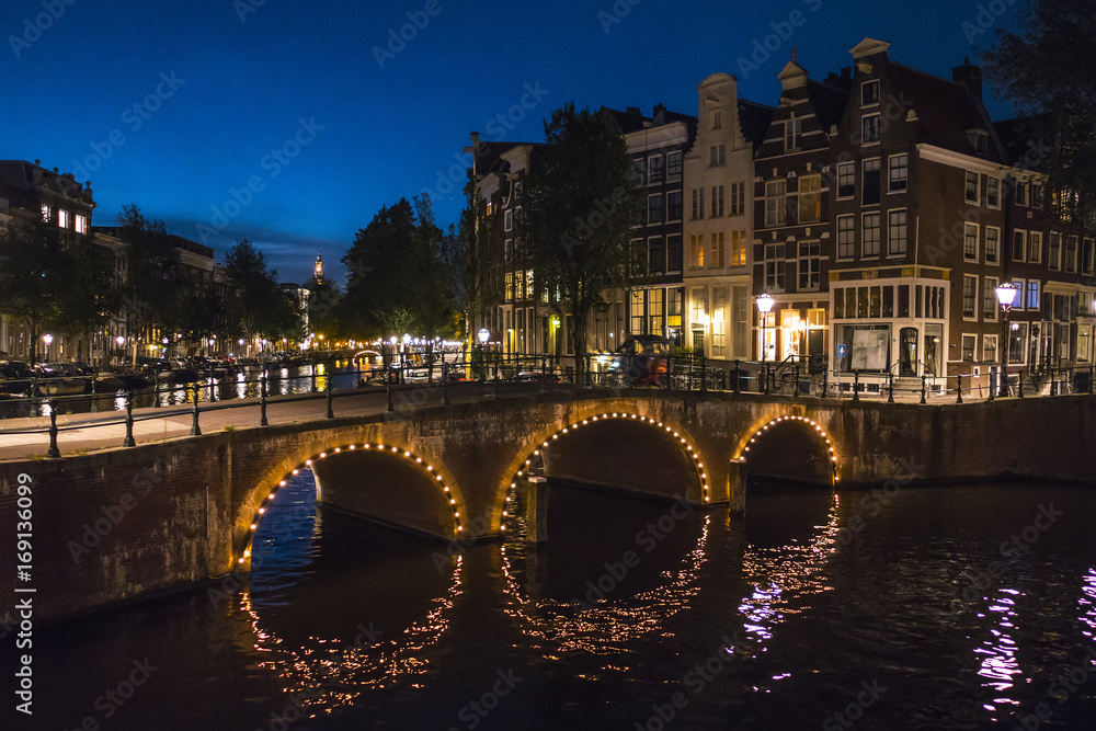 The canals of Amsterdam - illuminated by night The canals of Amsterdam - illuminated by night