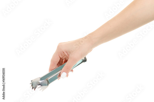 Female hands with kitchen tongs
