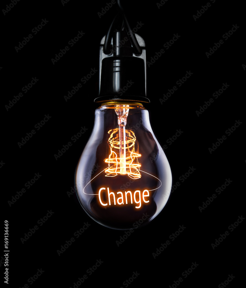 Hanging lightbulb with glowing Change concept.