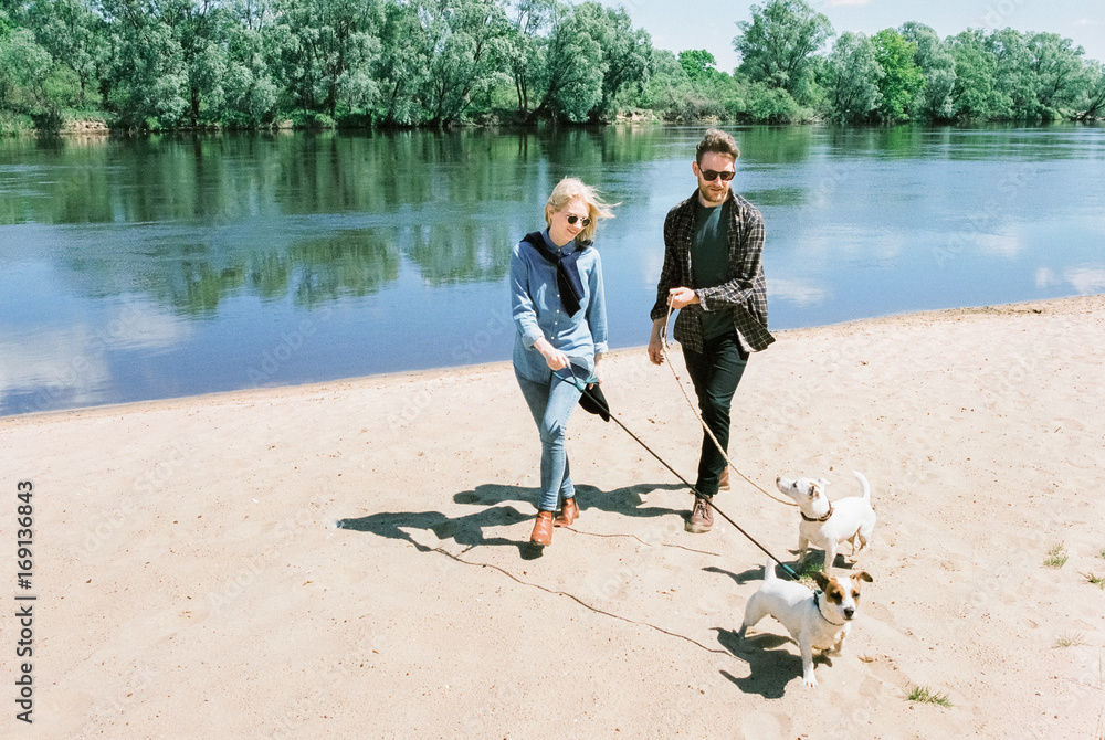 © Duet Postscriptum/Stocksy - Couple walk with his dogs © Duet Postscriptum/Stocksy - Couple walk with his dogs