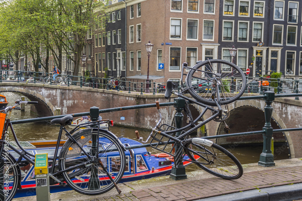 Bikes attached to a bridge in Amsterdam - AMSTERDAM - THE NETHERLANDS - JULY 20, 2017