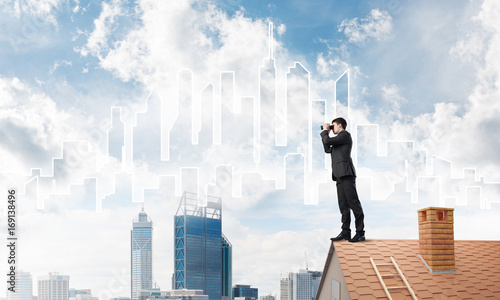 Businessman standing on roof and looking in binoculars. Mixed media © adam121