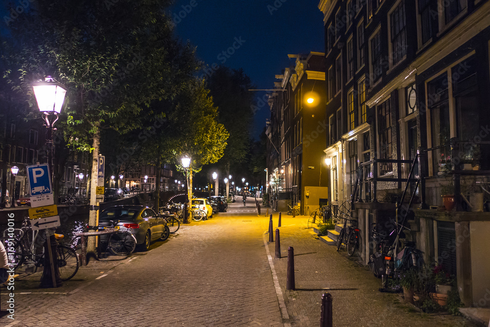 The sidewalks along the canals in Amsterdam by night