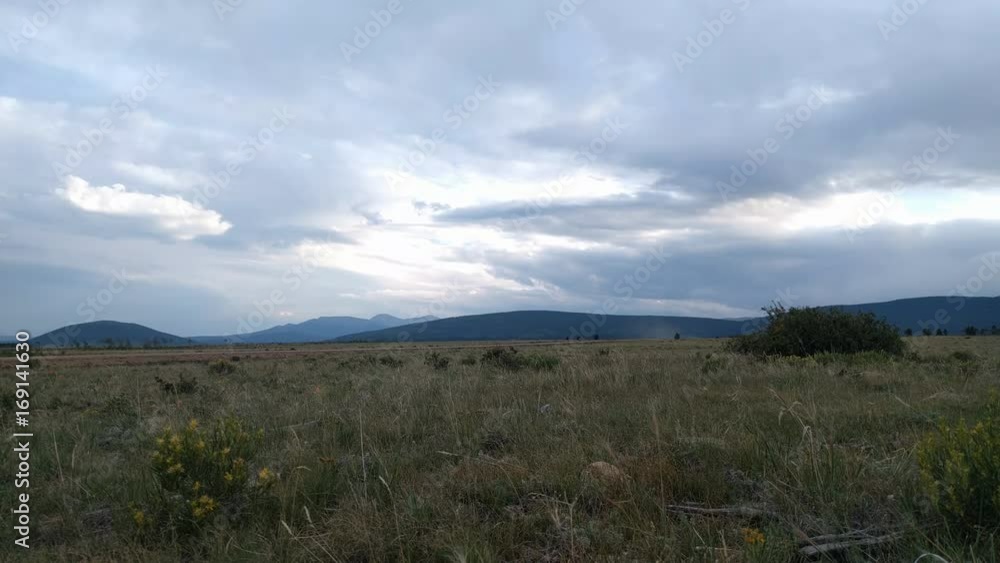 Colorado mountains in Fairplay in cloudy day and passing cars through gravel roar in time lapse. Colorado mountains in Fairplay in cloudy day and passing cars through gravel roar in time lapse.