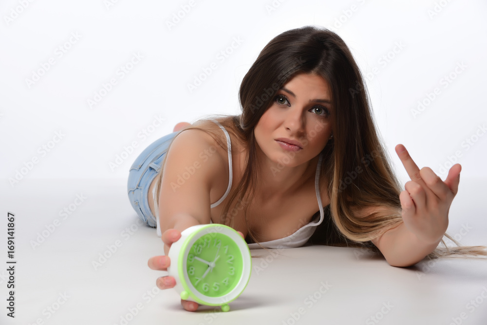 Beautiful sleeping woman resting in bed with alarm clock ready to wake her in the morning. Beautiful sleeping woman resting in bed with alarm clock ready to wake her in the morning.