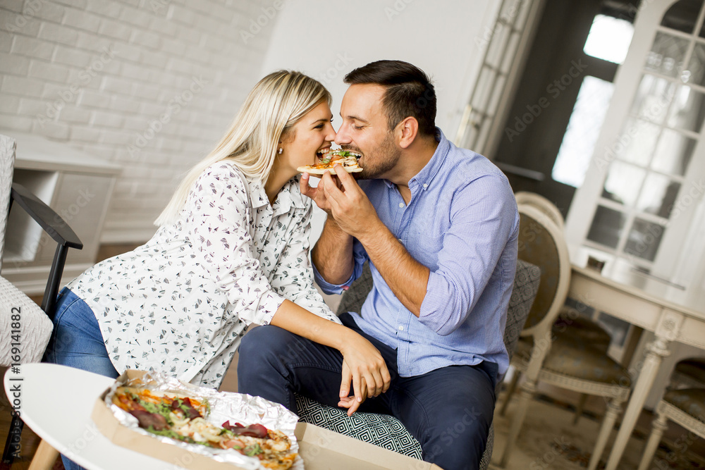 Lovely young couple eating pizza Lovely young couple eating pizza