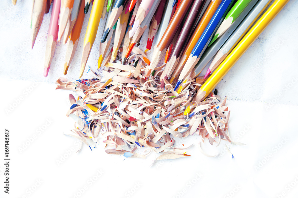 Many colored pencils with sawdust