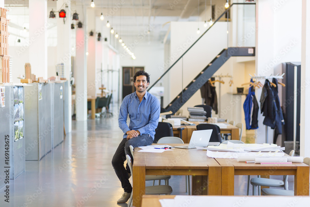 Young mixed race designer working in his spacious office Young mixed race designer working in his spacious office