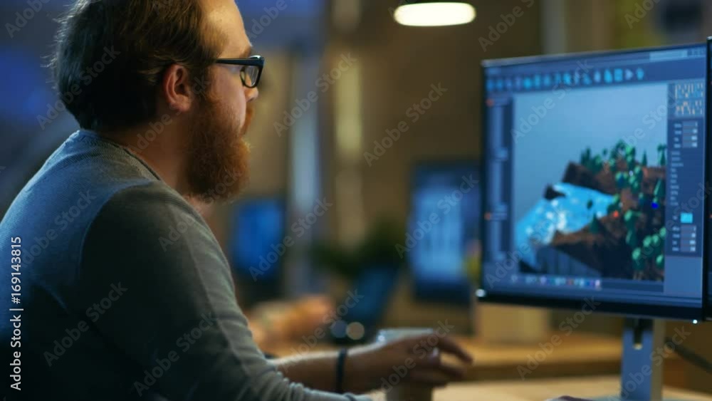 Male Game Developer Works on a New Level Design. He's Handsome Bearded ...