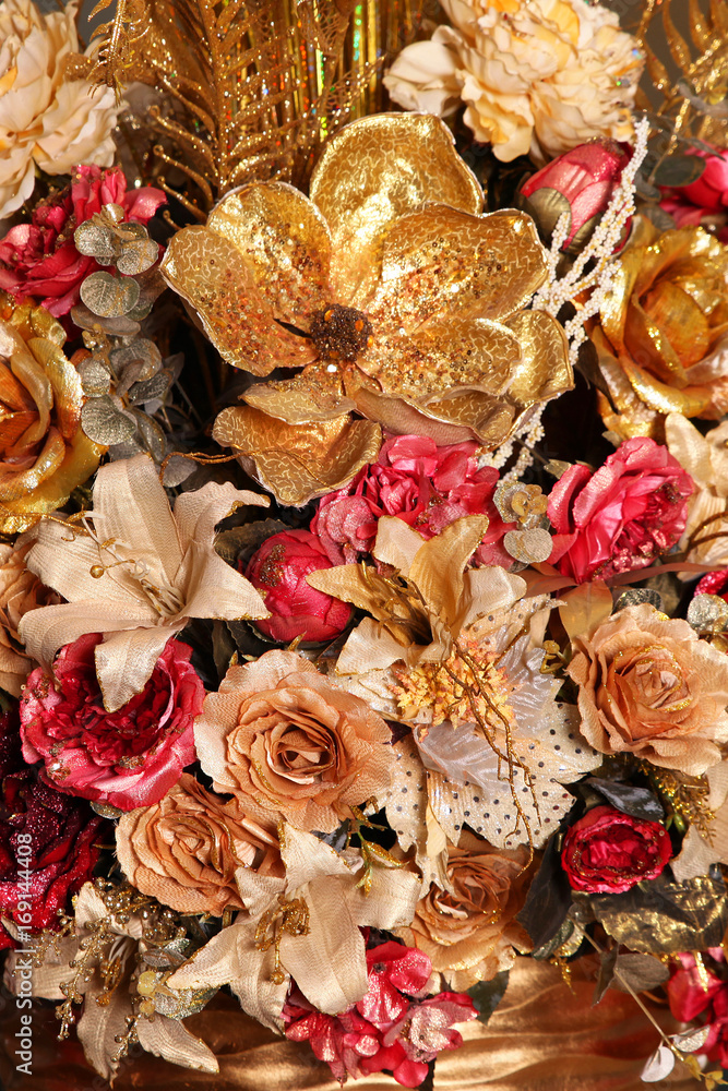 Artificial bouquet of flowers gold color