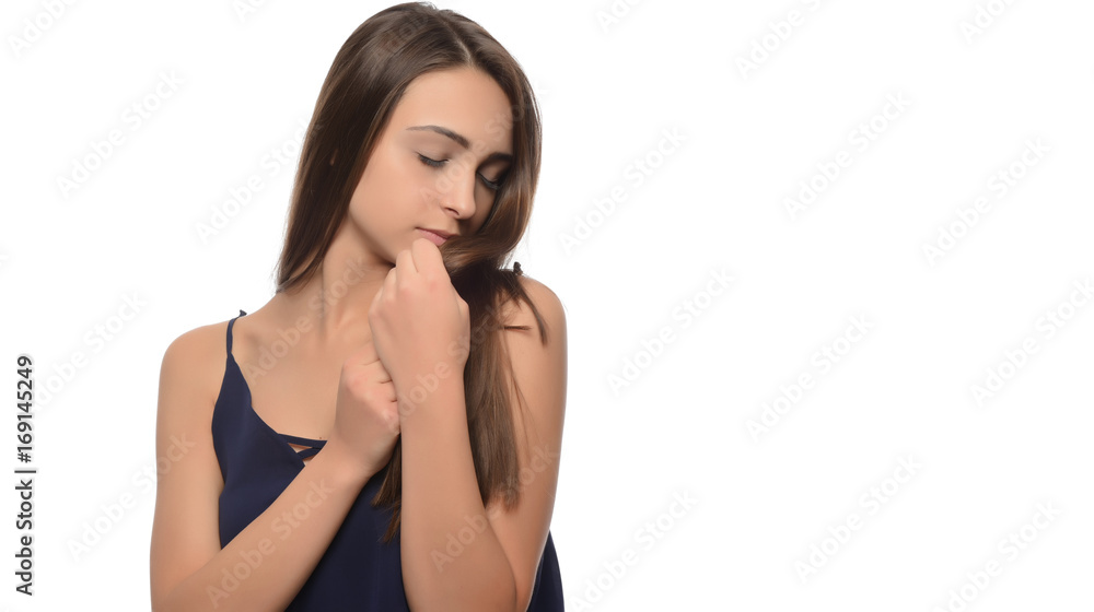 A young beautiful woman touching her hair. isolated A young beautiful woman touching her hair. isolated