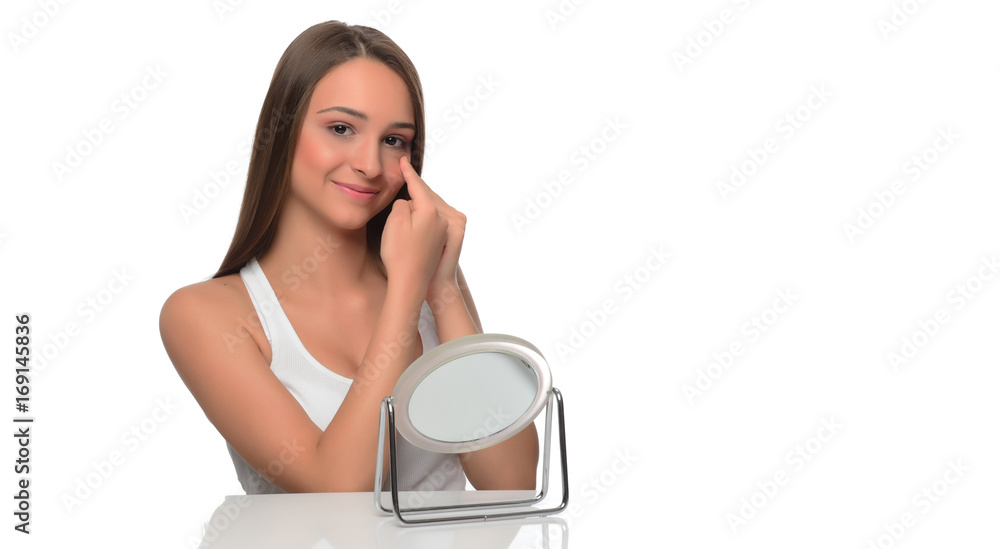 beautiful young female checking her facde skin beautiful young female checking her facde skin