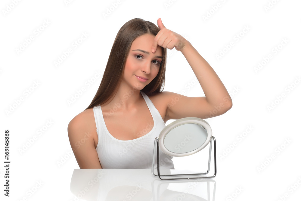 beautiful young female checking her facde skin beautiful young female checking her facde skin