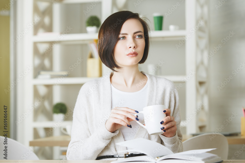Attractive young female drinking coffee Attractive young female drinking coffee