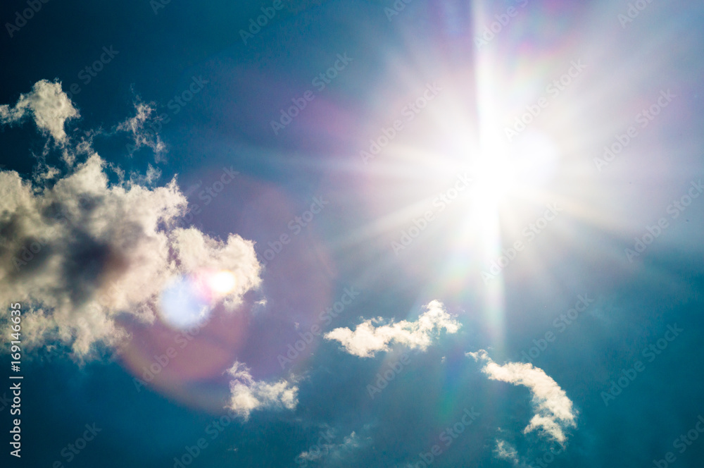 blue sky with sun flares in sunny summer day blue sky with sun flares in sunny summer day