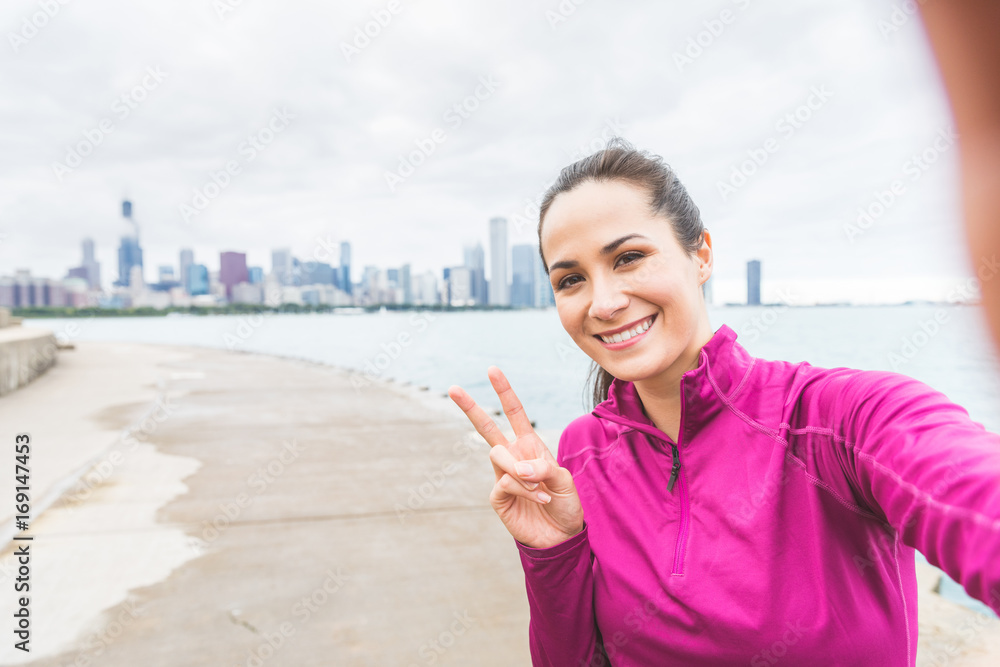 Woman taking a selfie after workout in Chicago Woman taking a selfie after workout in Chicago