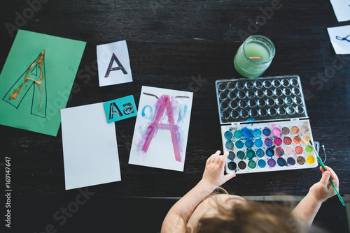 A child painting with watercolor for a homeschool activity 