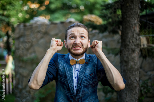 Fotografie portrait of young angry man. hands up. Man in despair