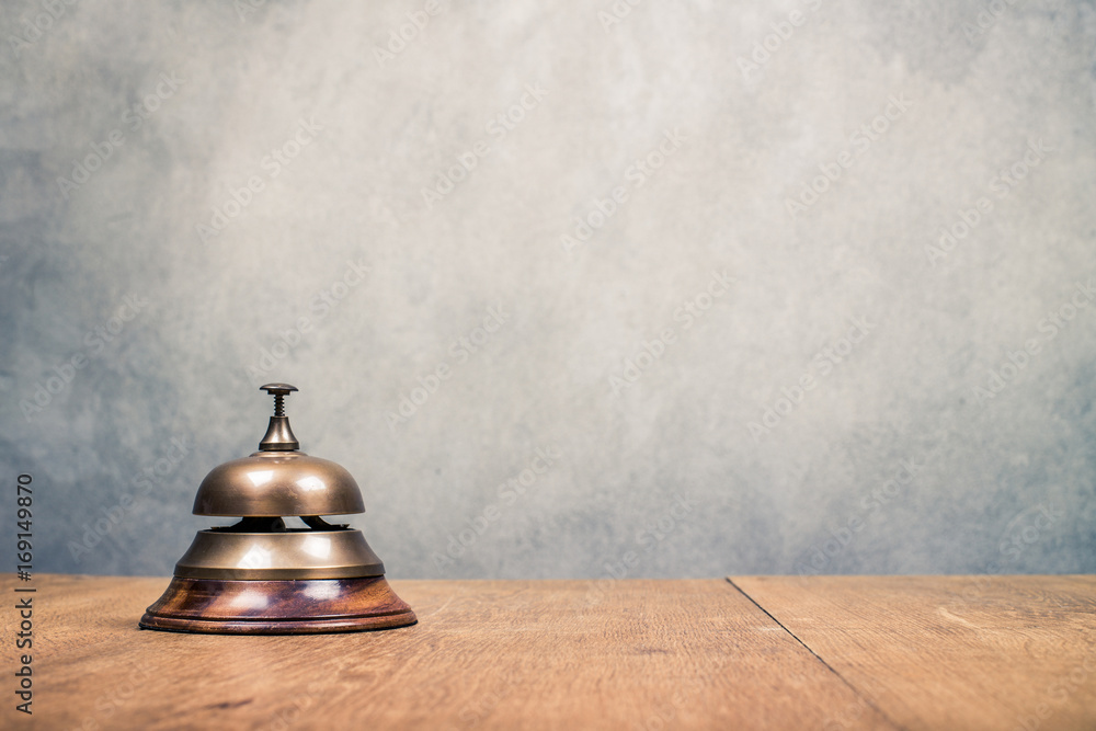 Vintage hotel reception service desk bell front textured concrete wall
