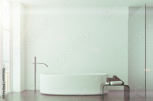 White bathroom, tiles and round tub toned