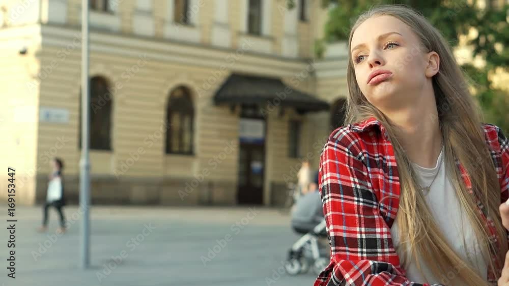Pretty girl looks tired after riding on rollerblades in the city, steadycam shot
Pretty girl looks tired after riding on rollerblades in the city, steadycam shot