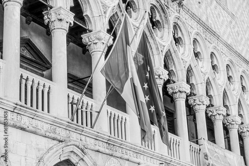 Italian and European flag attached to Doge s Palace in Venice photo