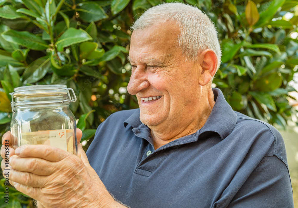 Old man looking jar full of banknotes Old man looking jar full of banknotes