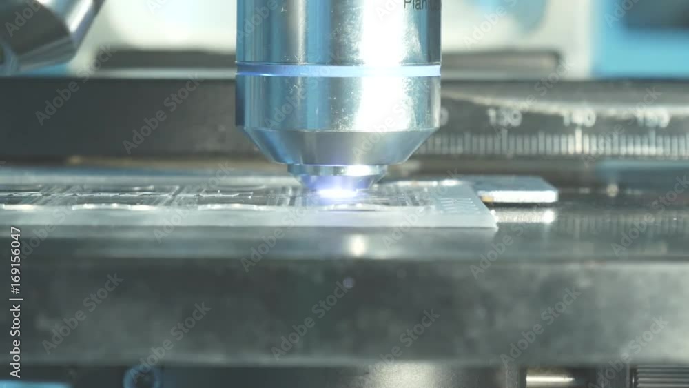 Close up on objective lens of microscope in laboratory. Close up on objective lens of microscope in laboratory.