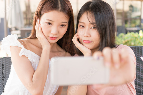 tow girls making selfie 