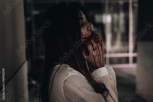 Zombie woman death the ghost drain hand blood skin is screaming darkness and nightmare background, horror of scary fear on hell is monster devil girl in halloween festival concept