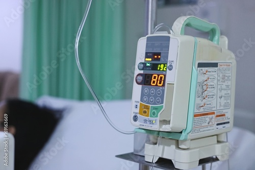 Infusion pump intravenous IV drip in the hospital with copy space background.