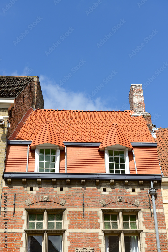 Traditional medieval brick house exterior with new tile roof