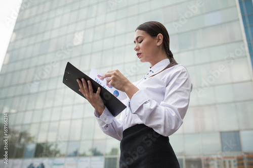 Business woman stands on the background of business center.