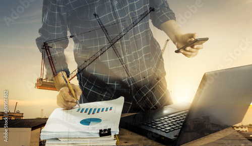 Double exposure of businessman and paperwork working with laptop and planing project construction. Business and construction concept.