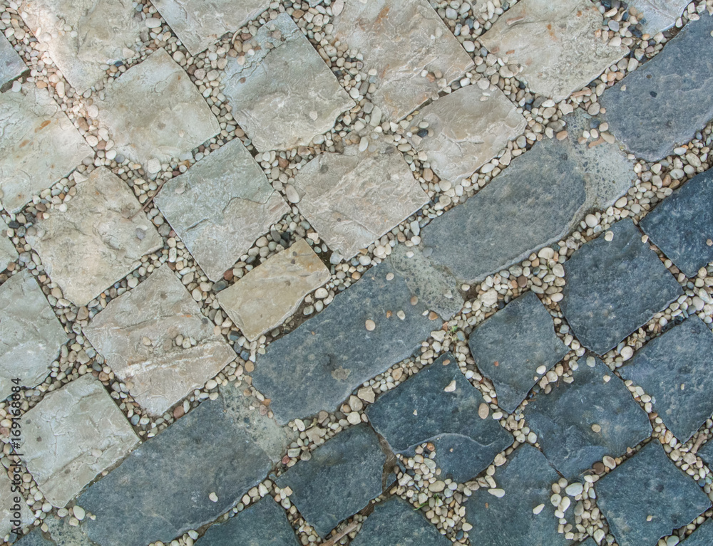 Obraz premium Dark and light gray granite stone pavement texture, abstract cobblestone pavement close-up.
