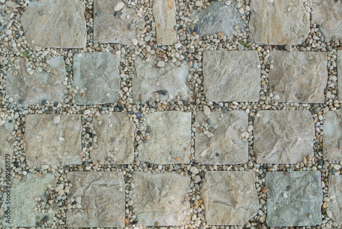 Light gray granite stone pavement texture, abstract cobblestone pavement close-up.