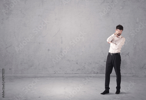 Young businessman standing confused