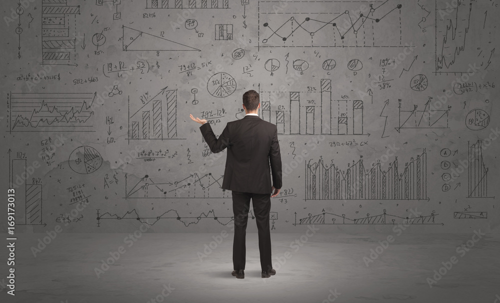 Salesman with business charts on wall Salesman with business charts on wall