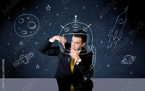 Sales person drawing helmet and space rocket