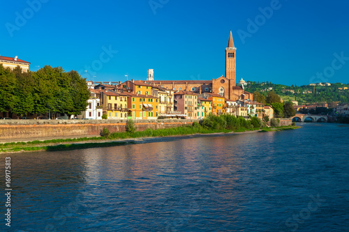 VERONA, ITALY. September 08, 2016: Morning scenery with Adige River, Bell tower of Santa Anastasia's church and the embankment of Adige River.