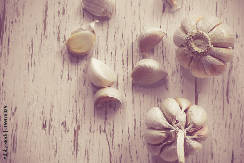 Fresh garlic on rustic wood and bokeh background Fresh garlic on rustic wood and bokeh background