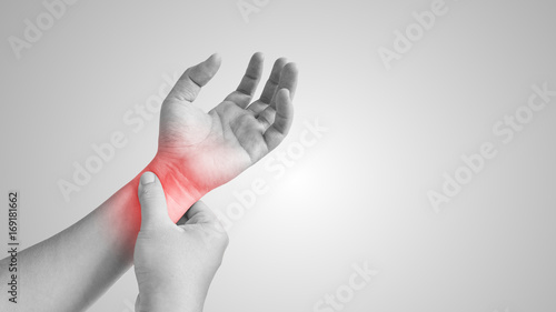 Pain in wrist, isolated in a white background. Red circle around the painful area. photo